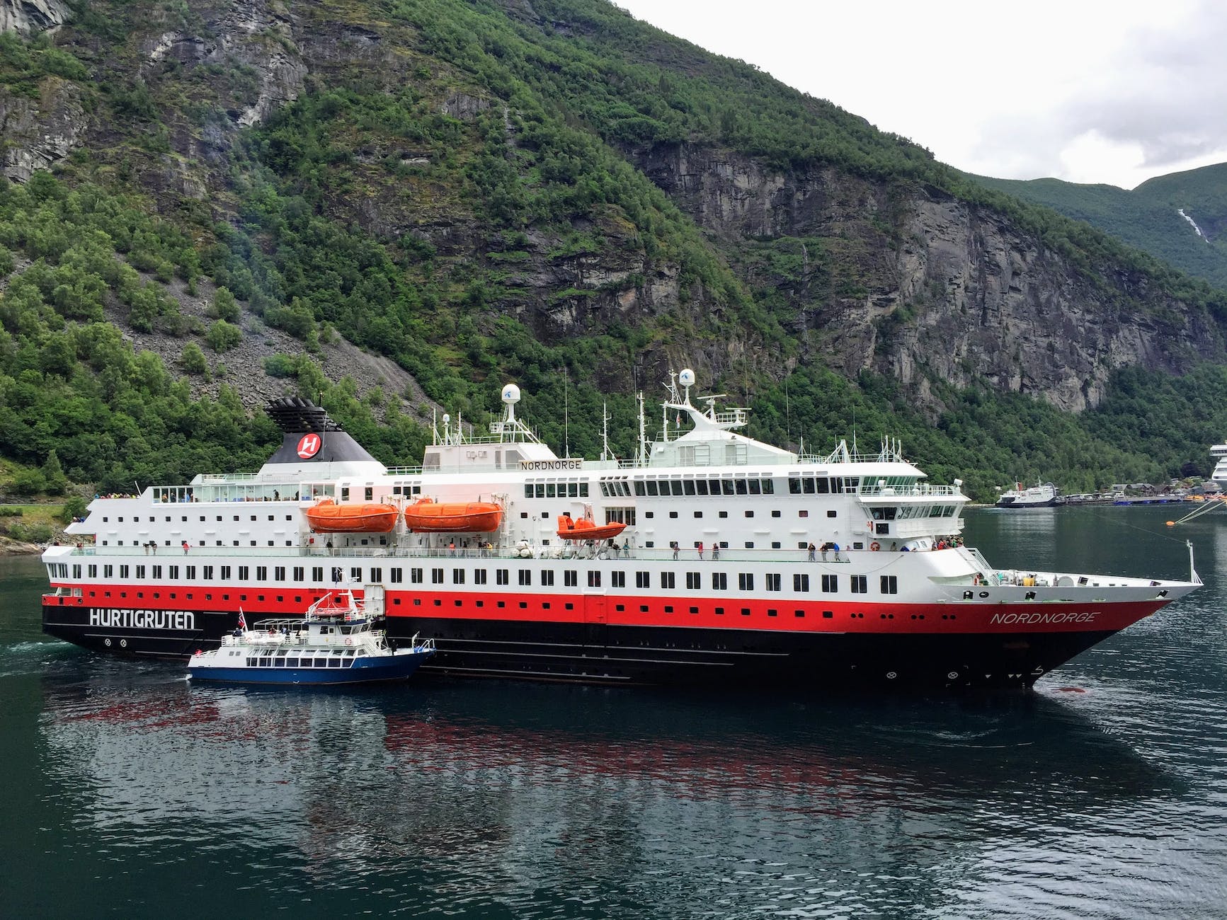 white and red cruise ship on water