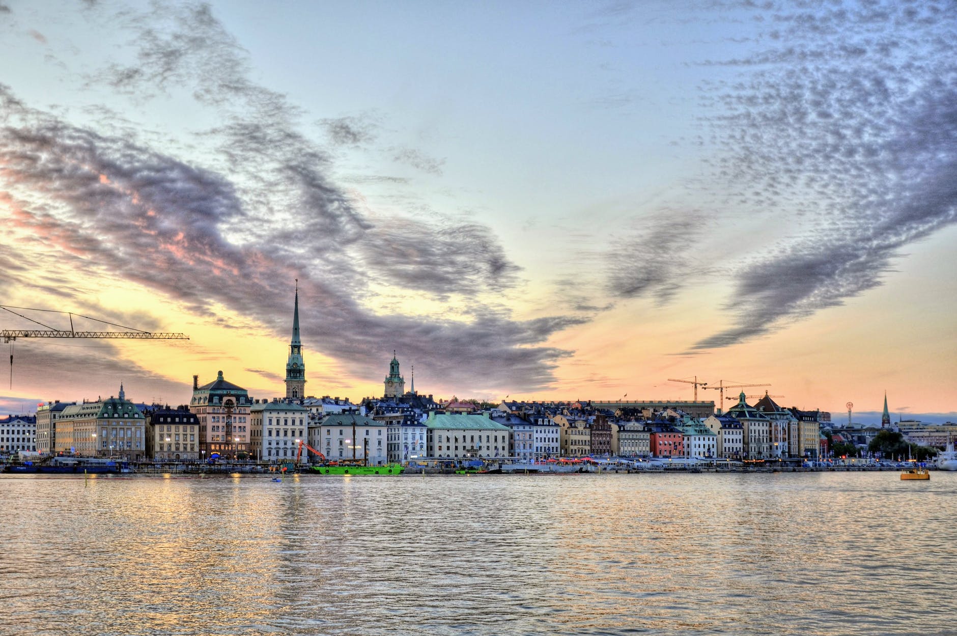 stockholm skyline beside water during sunset
