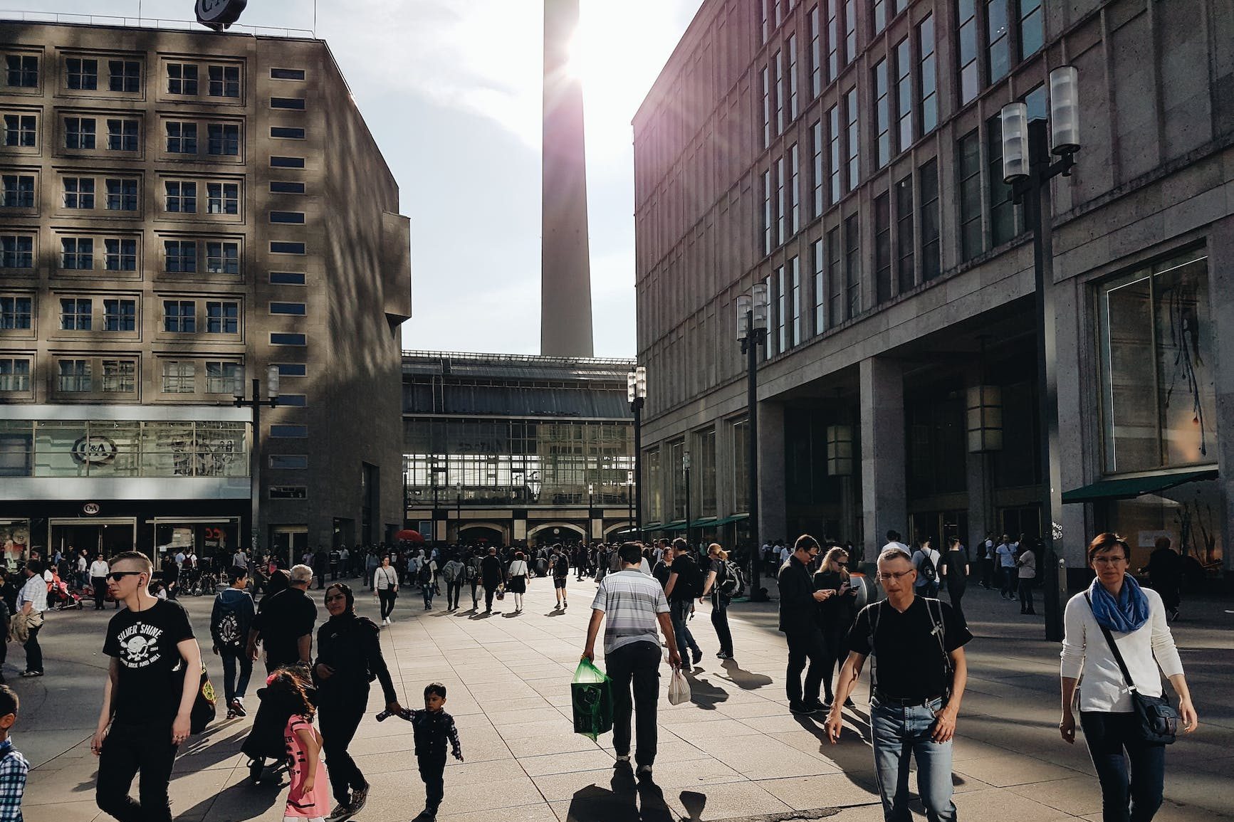 man in black crew neck t shirt walking near building