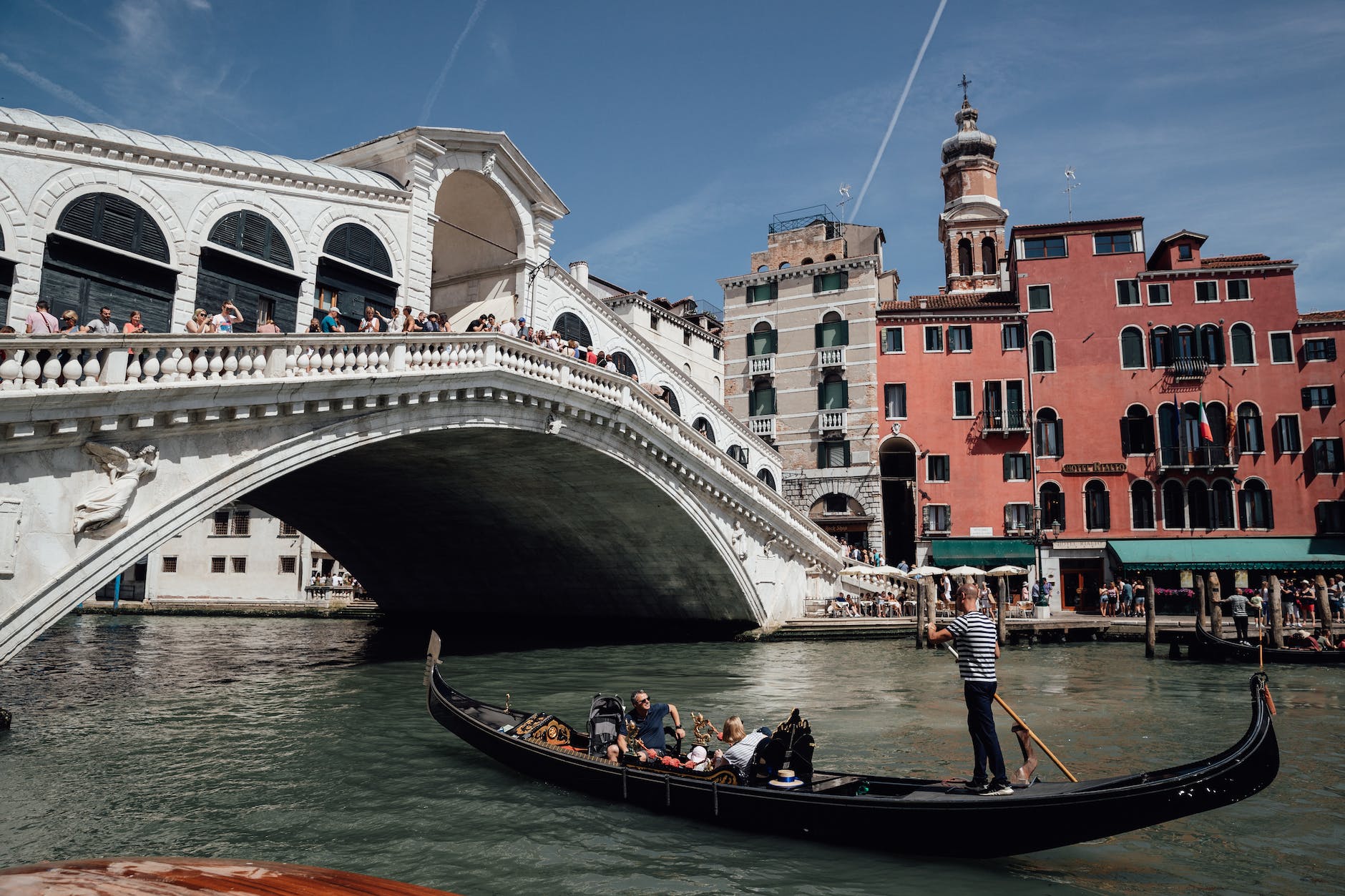 people floating on gondola near rialto bridge